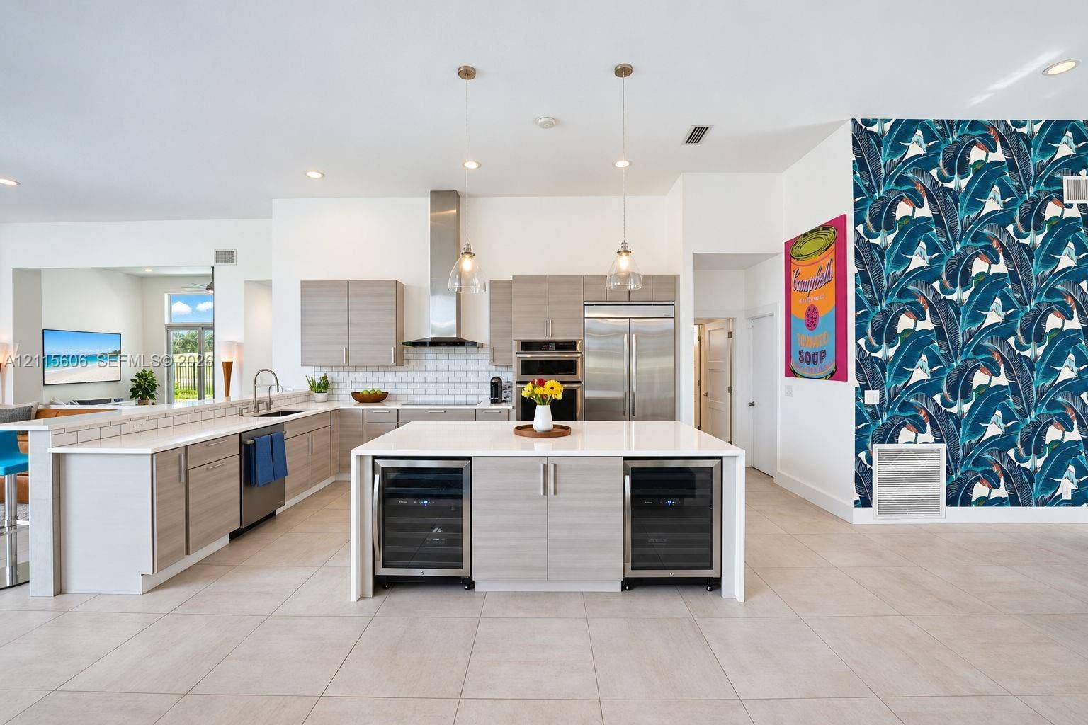 2652 Palmer Place, #2652, Weston, Weston, FL 33332 Kitchen featuring light-finish slab cabinetry, quartz countertops, stainless steel appliances, a central island with dual under-counter wine refrigerators, and pendant lighting