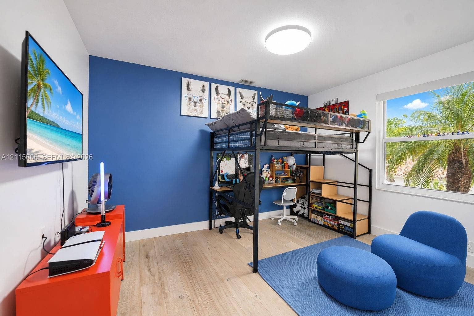 2652 Palmer Place, #2652, Weston, Weston, FL 33332 Room featuring wood-finish flooring, a vibrant blue accent wall, and a large horizontal window