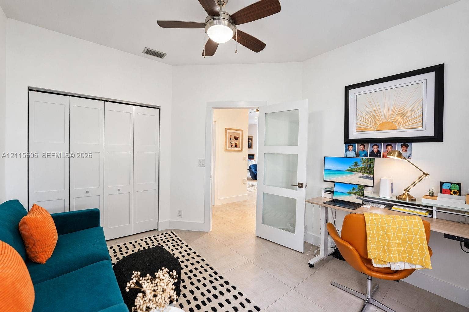 2652 Palmer Place, #2652, Weston, Weston, FL 33332 Interior room featuring neutral tile flooring, a multi-panel closet with white doors, a ceiling fan with integrated lighting, and a white interior door with three frosted glass panels