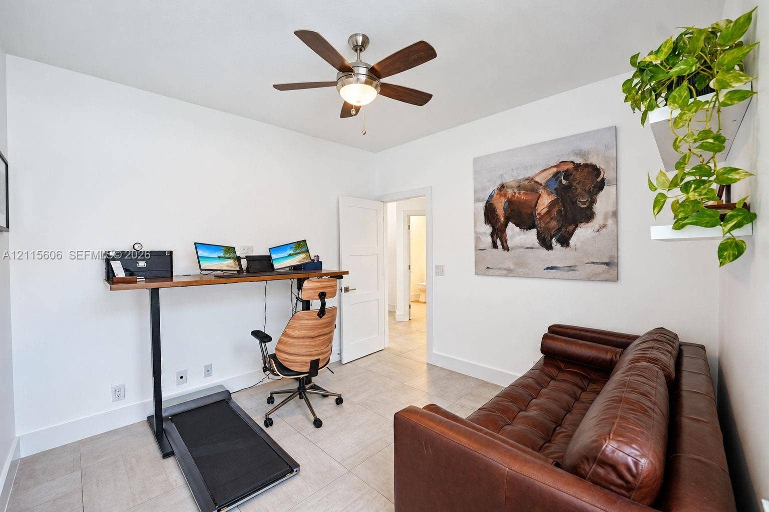2652 Palmer Place, #2652, Weston, Weston, FL 33332 Neutral-toned tile flooring, white shaker-style interior door, and multi-blade ceiling fan with integrated light fixture