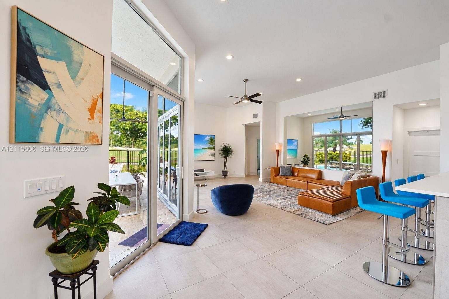 2652 Palmer Place, #2652, Weston, Weston, FL 33332 Open-concept interior featuring large-format tile flooring, recessed ceiling lighting, high ceilings, and floor-to-ceiling glass sliding doors