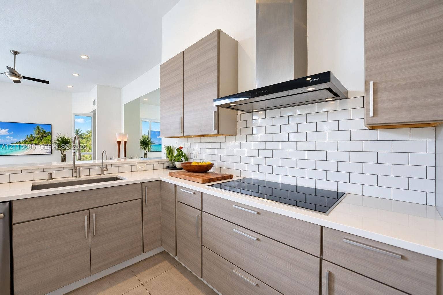 2652 Palmer Place, #2652, Weston, Weston, FL 33332 Kitchen featuring flat-panel wood-finish cabinetry, quartz countertops, white subway tile backsplash, stainless steel range hood, and integrated induction cooktop