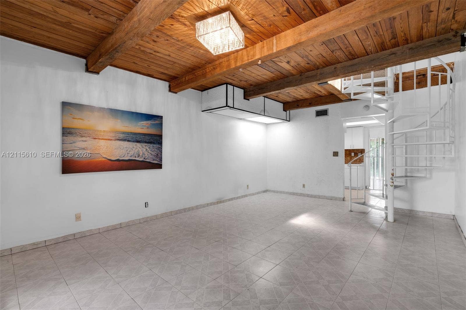 3711 Riverside Drive, Coral Springs, FL 33065 Exposed wood-beam ceiling featuring natural finish planks, white spiral staircase, tile flooring, and integrated rectangular flush-mount lighting