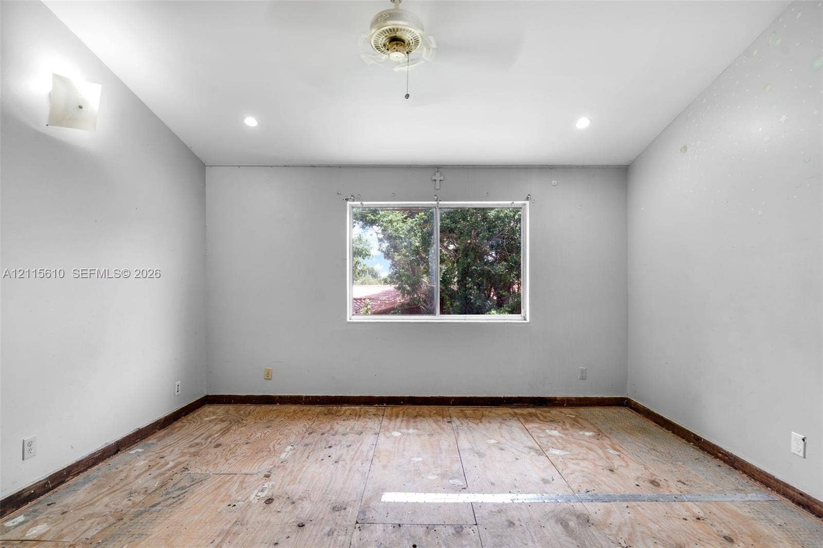 3711 Riverside Drive, Coral Springs, FL 33065 Room featuring neutral wall finishes, recessed lighting, a ceiling fan, and a centered window with natural landscape exposure
