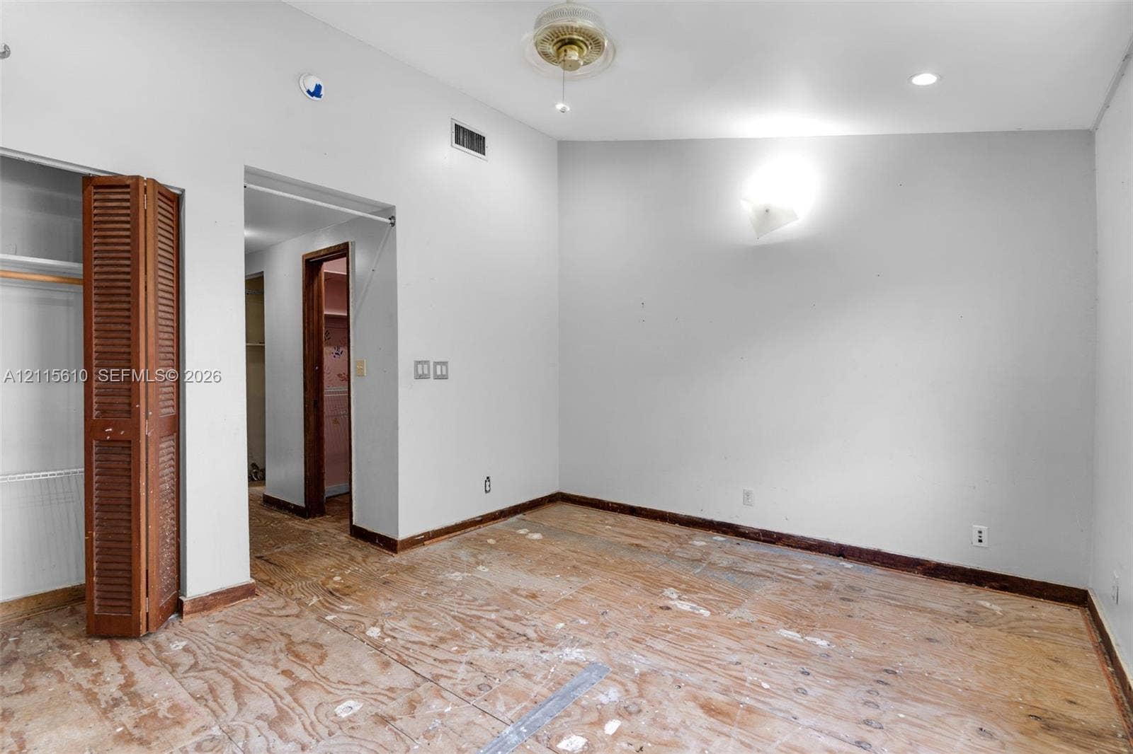 3711 Riverside Drive, Coral Springs, FL 33065 Room featuring a vaulted ceiling, recessed lighting, ceiling fan, and louvered bifold closet doors