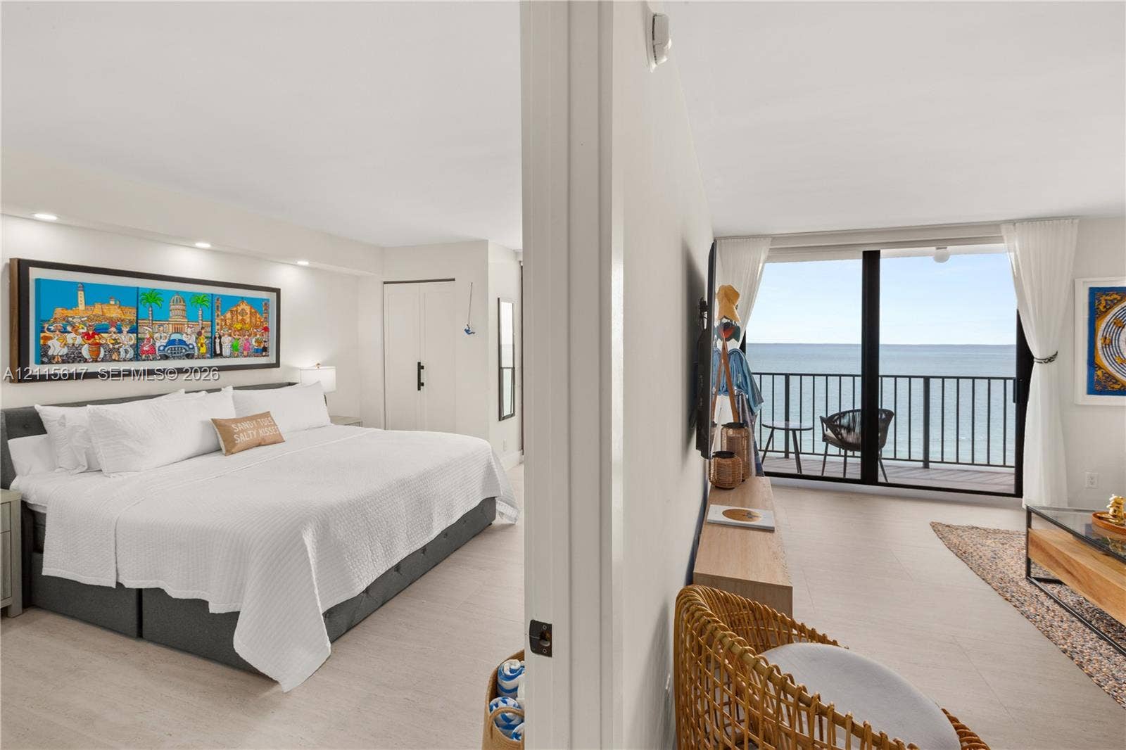 Interior space featuring tile flooring, recessed lighting, and large sliding glass doors leading to an exterior balcony with metal railing