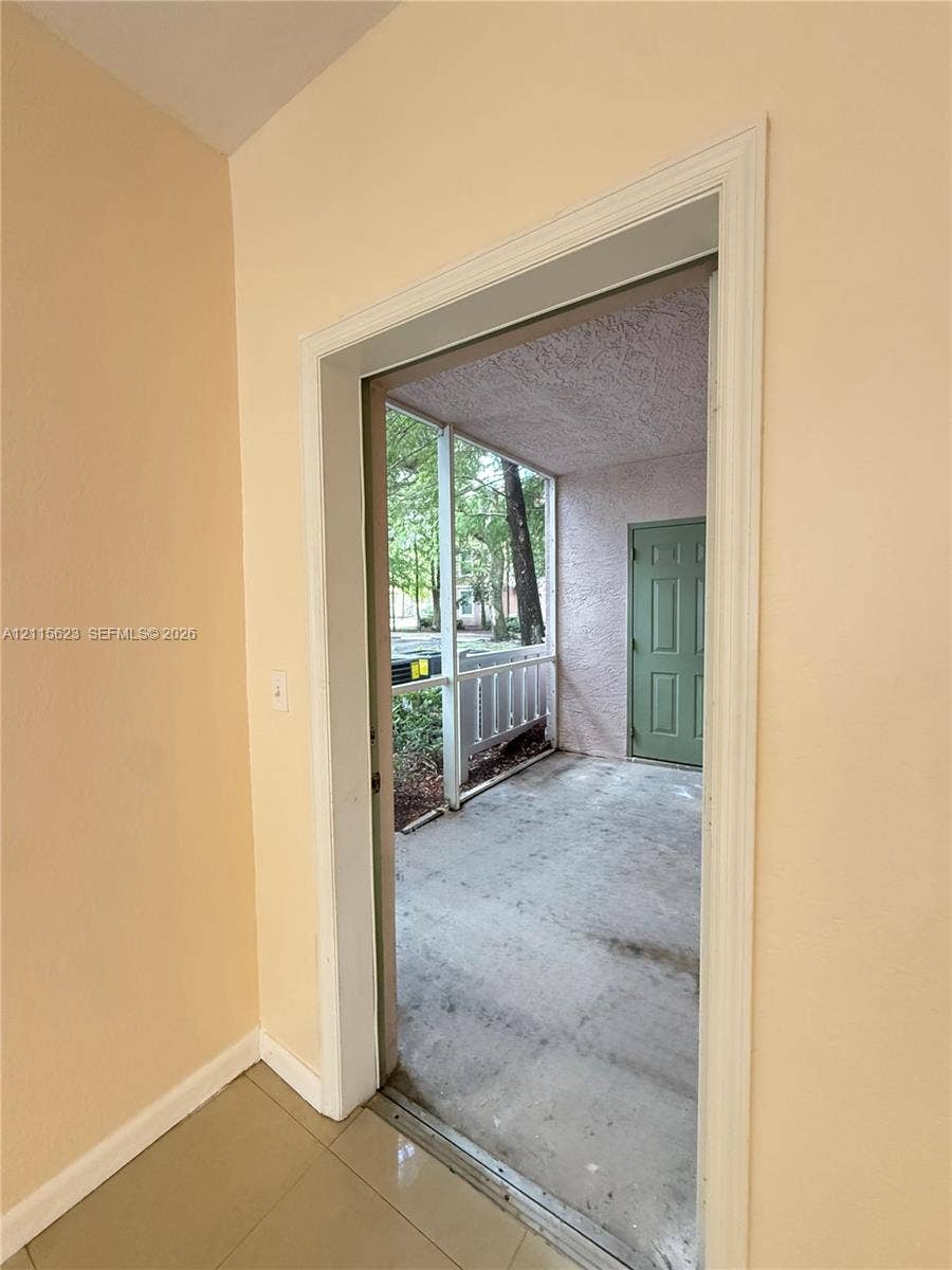 6796 W Sample Road, #6796, Coral Springs, Coral Springs, FL 33067 Screened-in porch featuring a concrete floor and a solid-core six-panel door
