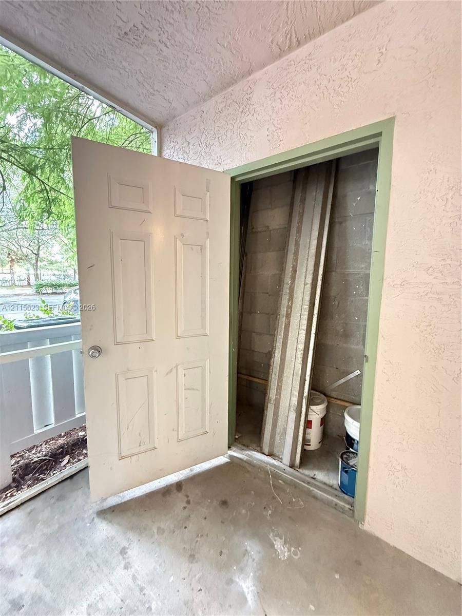 6796 W Sample Road, #6796, Coral Springs, Coral Springs, FL 33067 Exterior storage closet with a six-panel door and concrete masonry unit walls