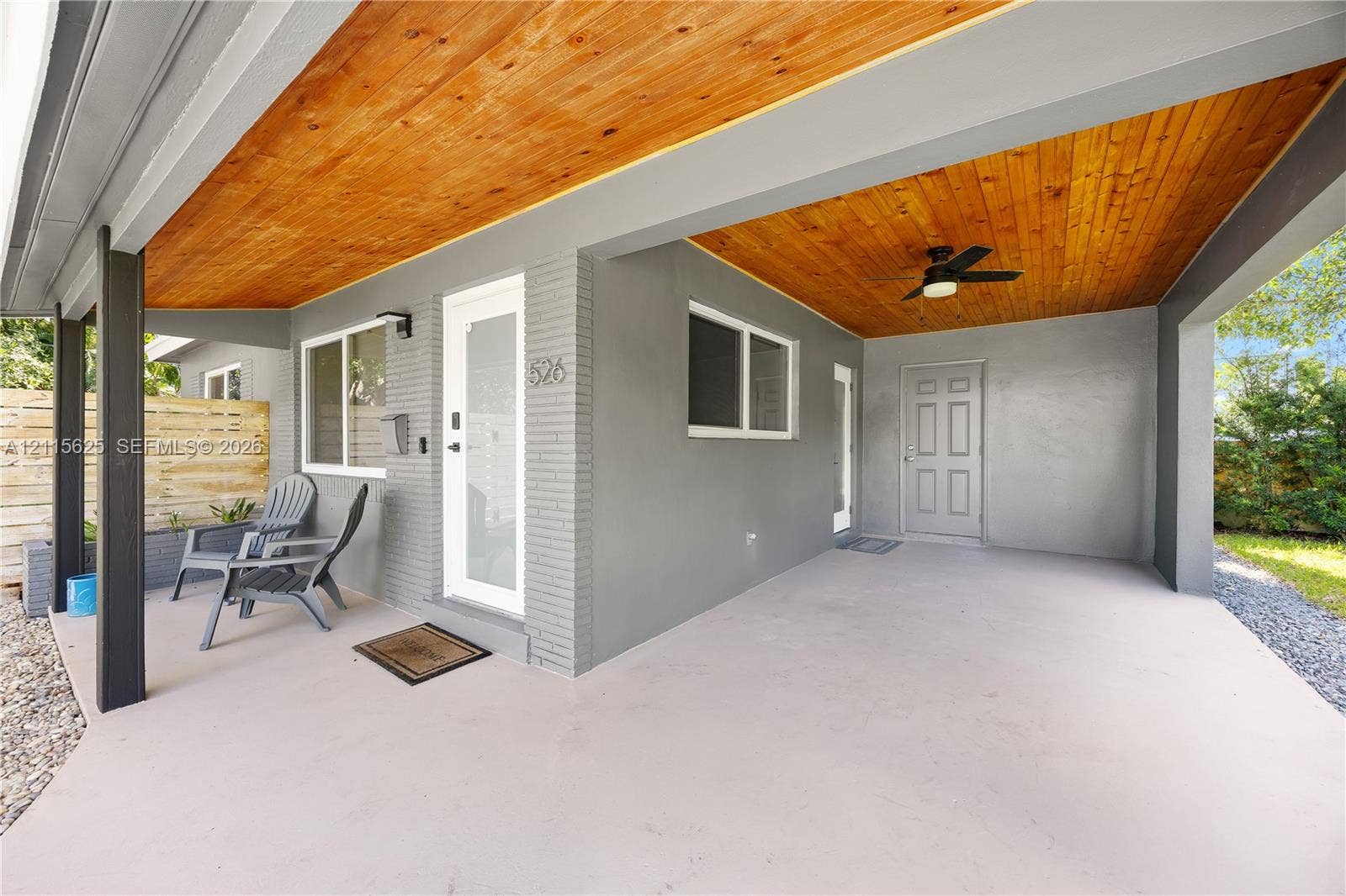 Covered patio featuring a wood-plank ceiling, recessed lighting, a ceiling fan, and painted brick exterior walls
