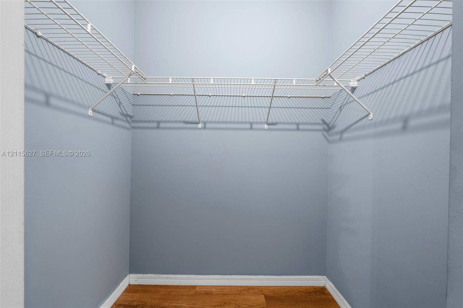 7085 Nova Drive, #218, Davie, FL 33317 Walk-in closet featuring white wire shelving and wood-finish flooring