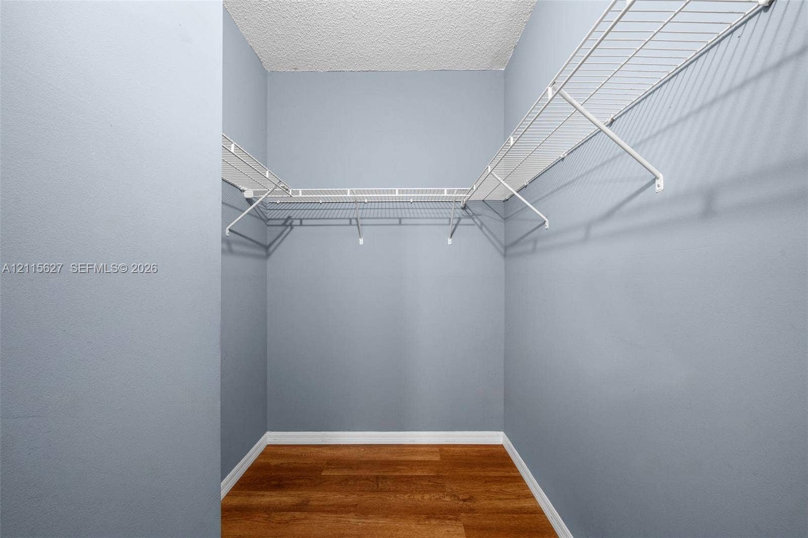 7085 Nova Drive, #218, Davie, FL 33317 Storage area featuring wood-finish flooring and white wire shelving