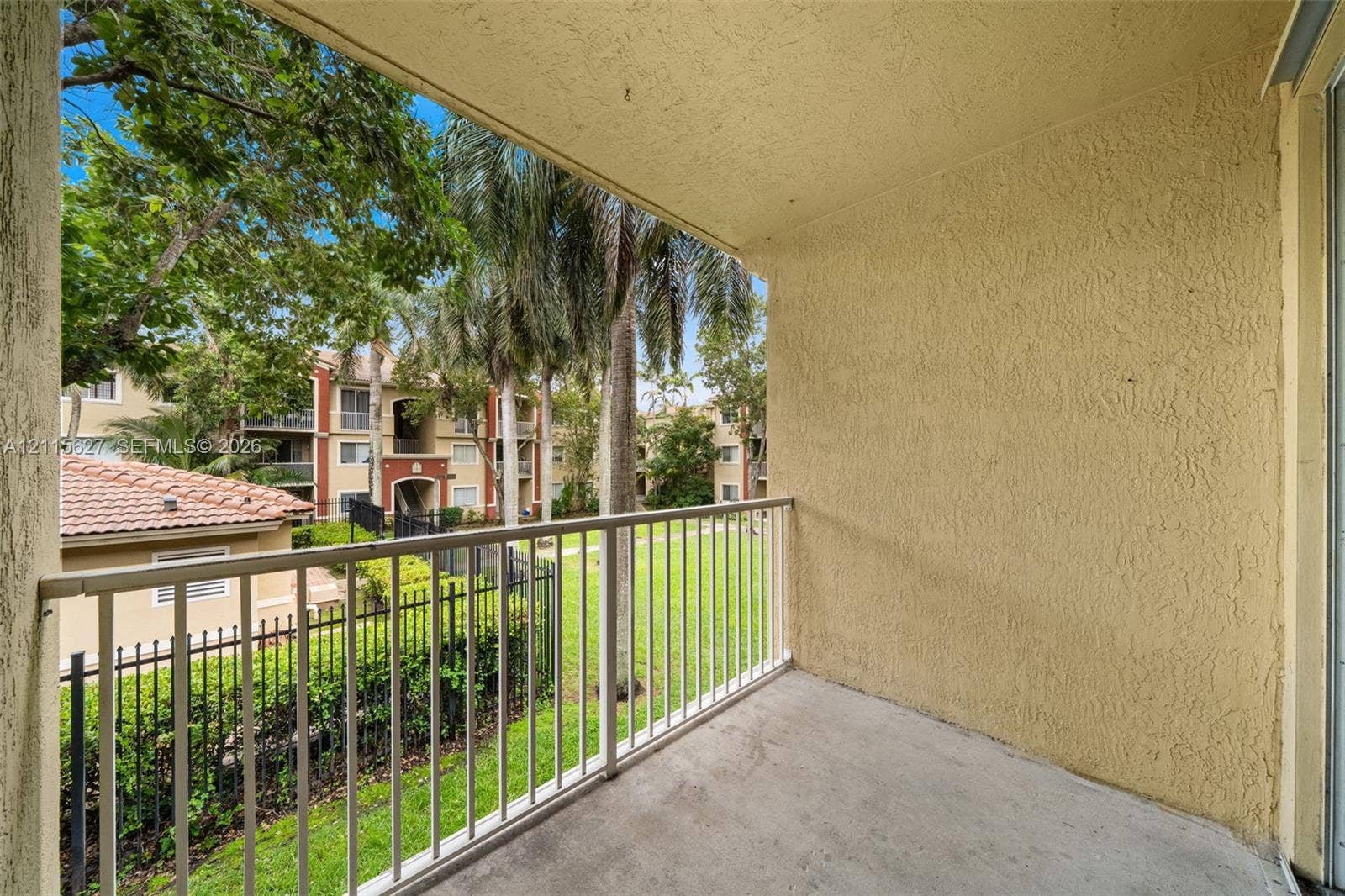 7085 Nova Drive, #218, Davie, FL 33317 Covered balcony featuring a concrete floor, stucco walls, and metal railing