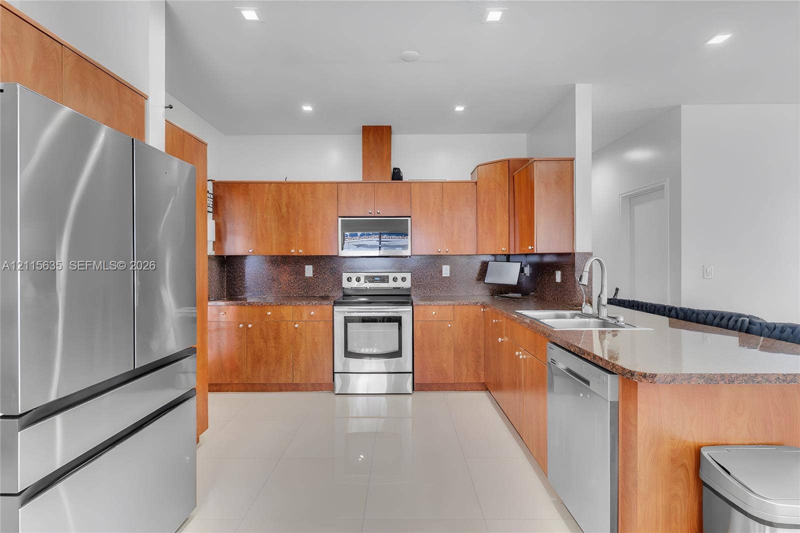 15374 SW 113th Terrace, Miami, FL 33196 Kitchen featuring wood cabinetry, stone countertops, stainless steel appliances, a tile backsplash, and recessed lighting