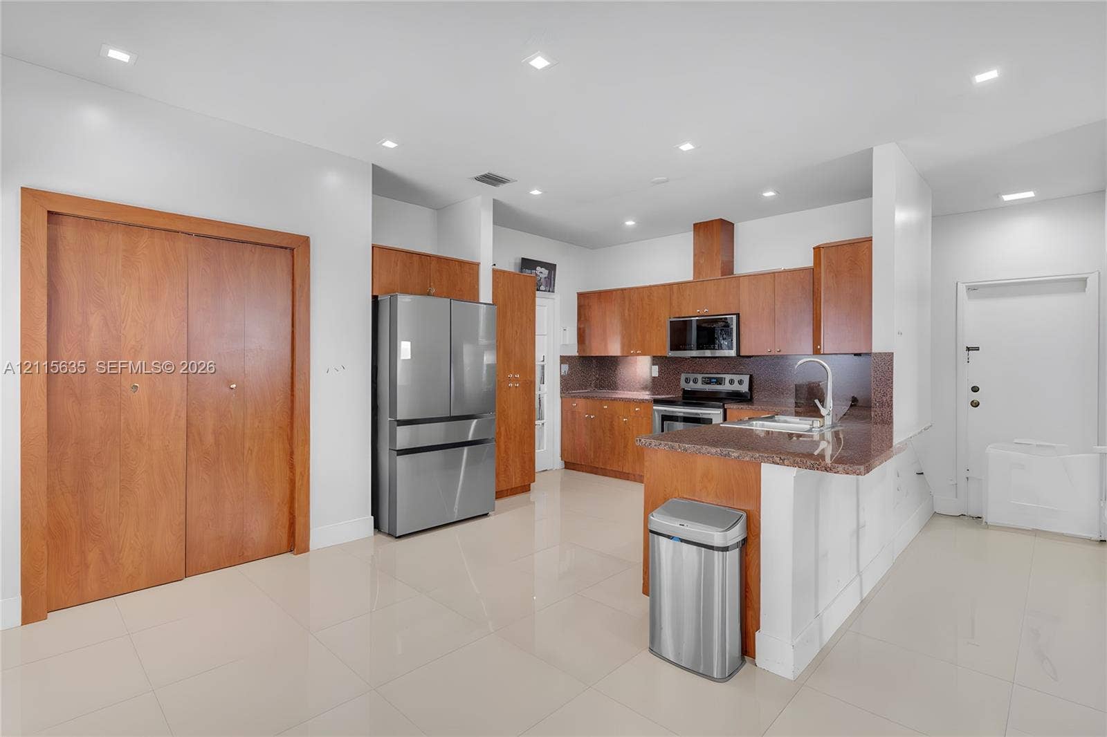 15374 SW 113th Terrace, Miami, FL 33196 Kitchen featuring wood cabinetry, stone countertops, stainless steel appliances, tile flooring, and recessed ceiling lighting