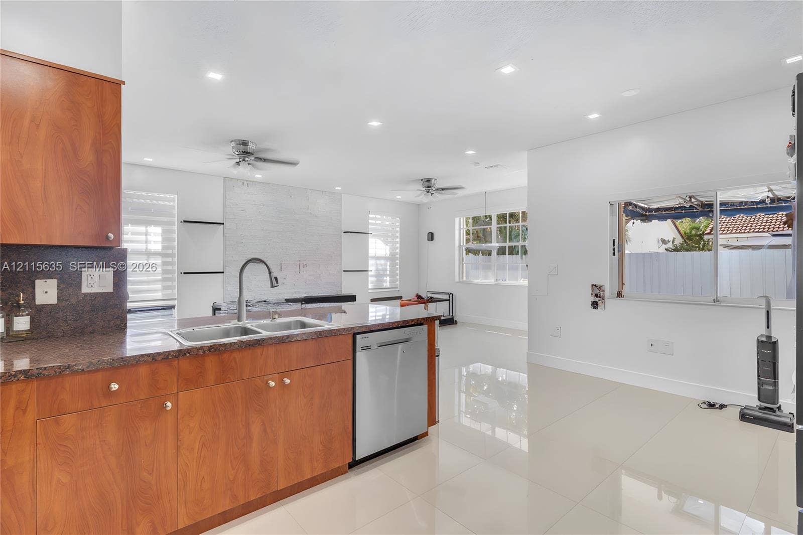 15374 SW 113th Terrace, Miami, FL 33196 Kitchen featuring wood-finish cabinetry, stone-surface countertops, stainless steel dishwasher, recessed lighting, and tile flooring