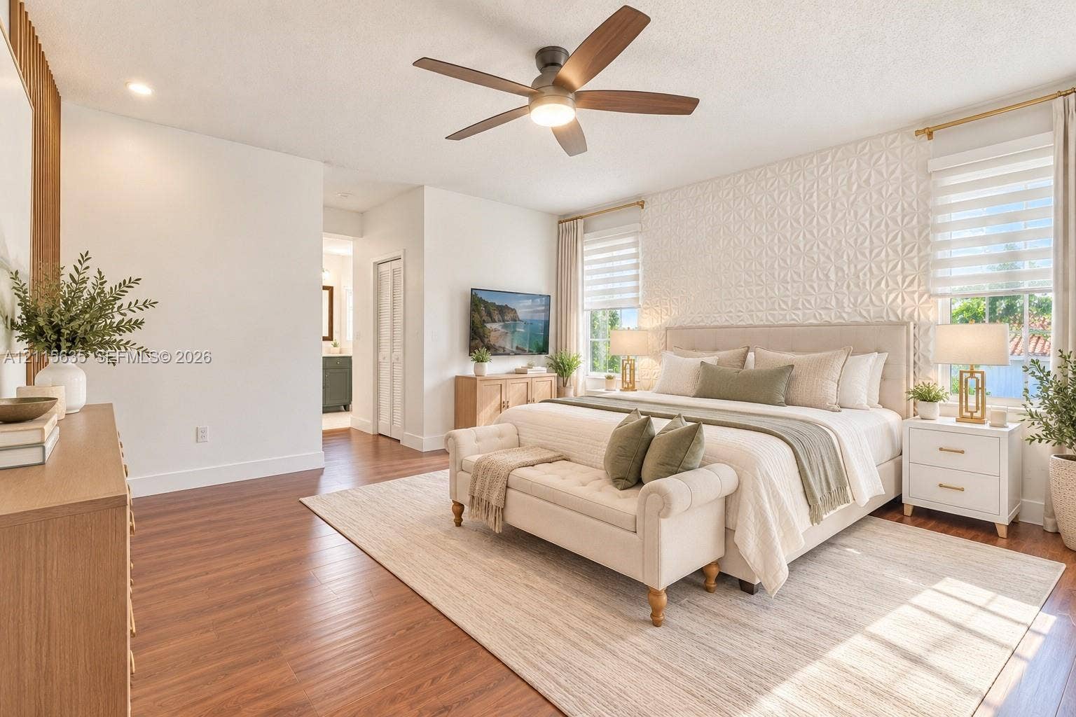 15374 SW 113th Terrace, Miami, FL 33196 Bedroom featuring wood-finish flooring, a textured geometric accent wall, a central ceiling fan with integrated lighting, and dual windows with layered window treatments