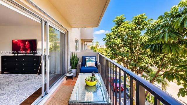 3860 NE 170th Street, #310, North Miami Beach, FL 33160 Private balcony featuring terracotta-style tile flooring and black metal railing