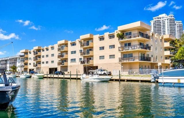 3860 NE 170th Street, #310, North Miami Beach, FL 33160 Waterfront multi-story building featuring private balconies, bulkhead docking, and covered ground-level parking
