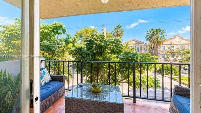 3860 NE 170th Street, #310, North Miami Beach, FL 33160 Covered balcony featuring tile flooring and a black metal railing
