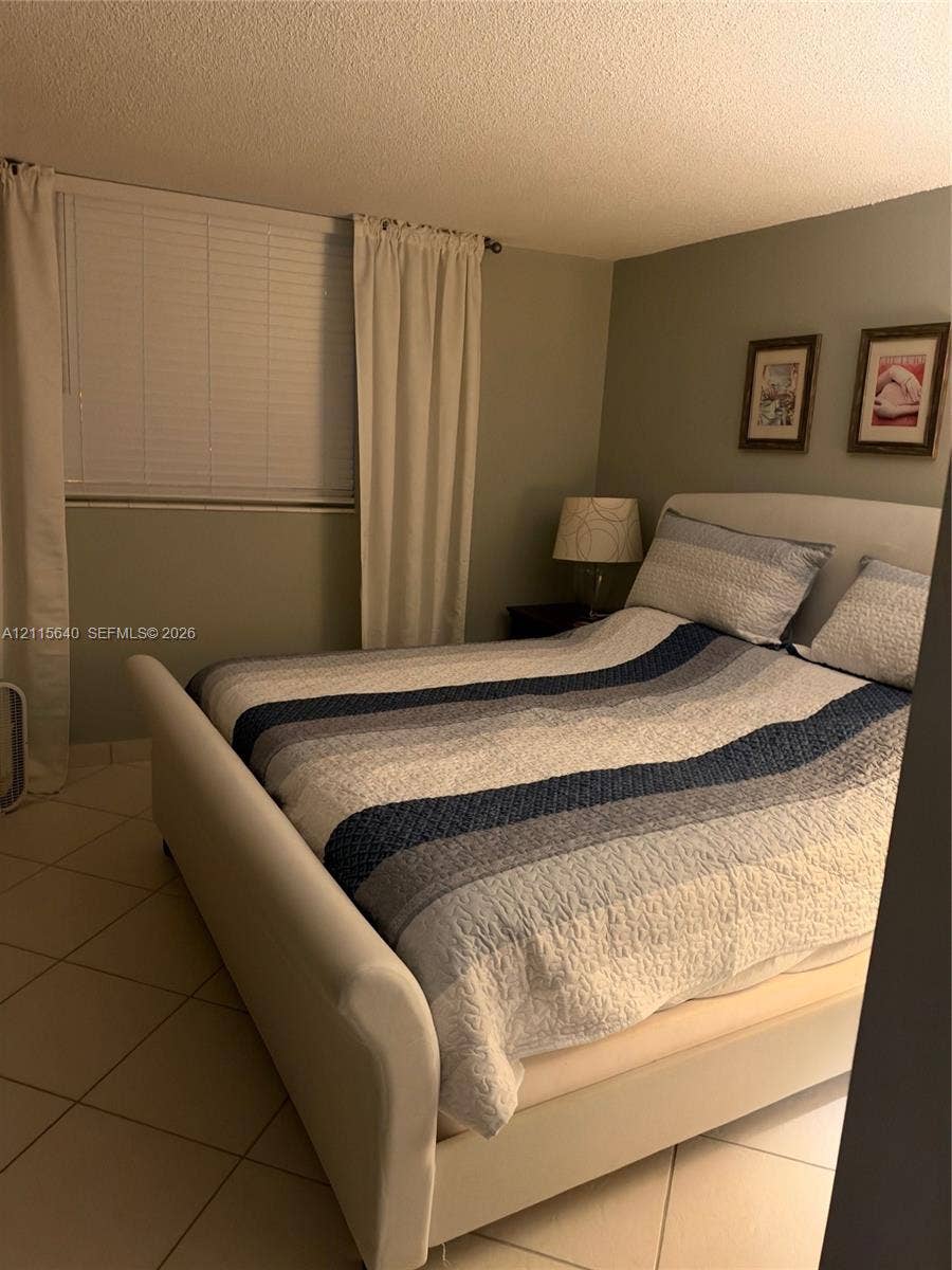 1913 S Ocean Drive, #426, Hallandale Beach, Hallandale Beach, FL 33009 Neutral-toned interior walls, oversized ceramic floor tiling, and horizontal slat window blinds