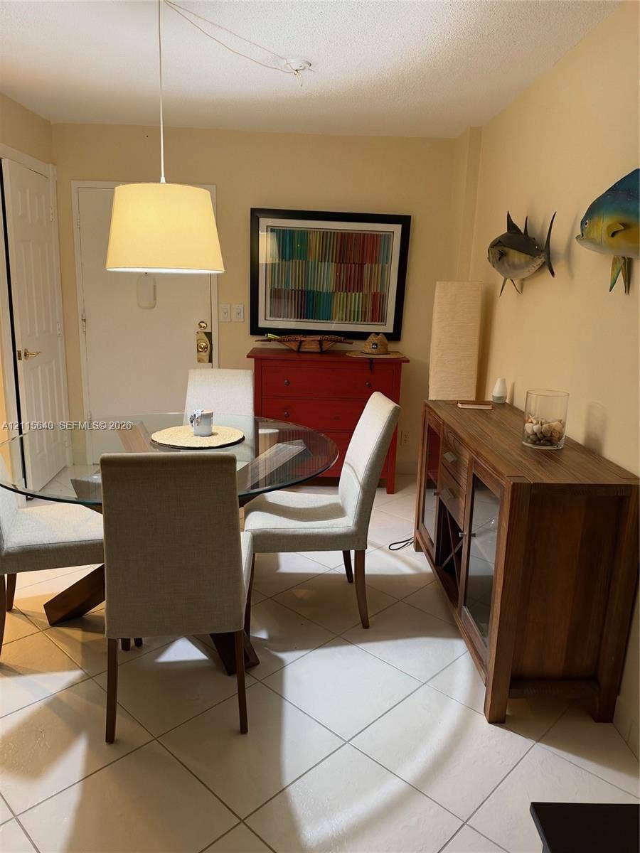 1913 S Ocean Drive, #426, Hallandale Beach, Hallandale Beach, FL 33009 Light-toned tile flooring throughout with a suspended drum pendant light fixture and a multi-panel door