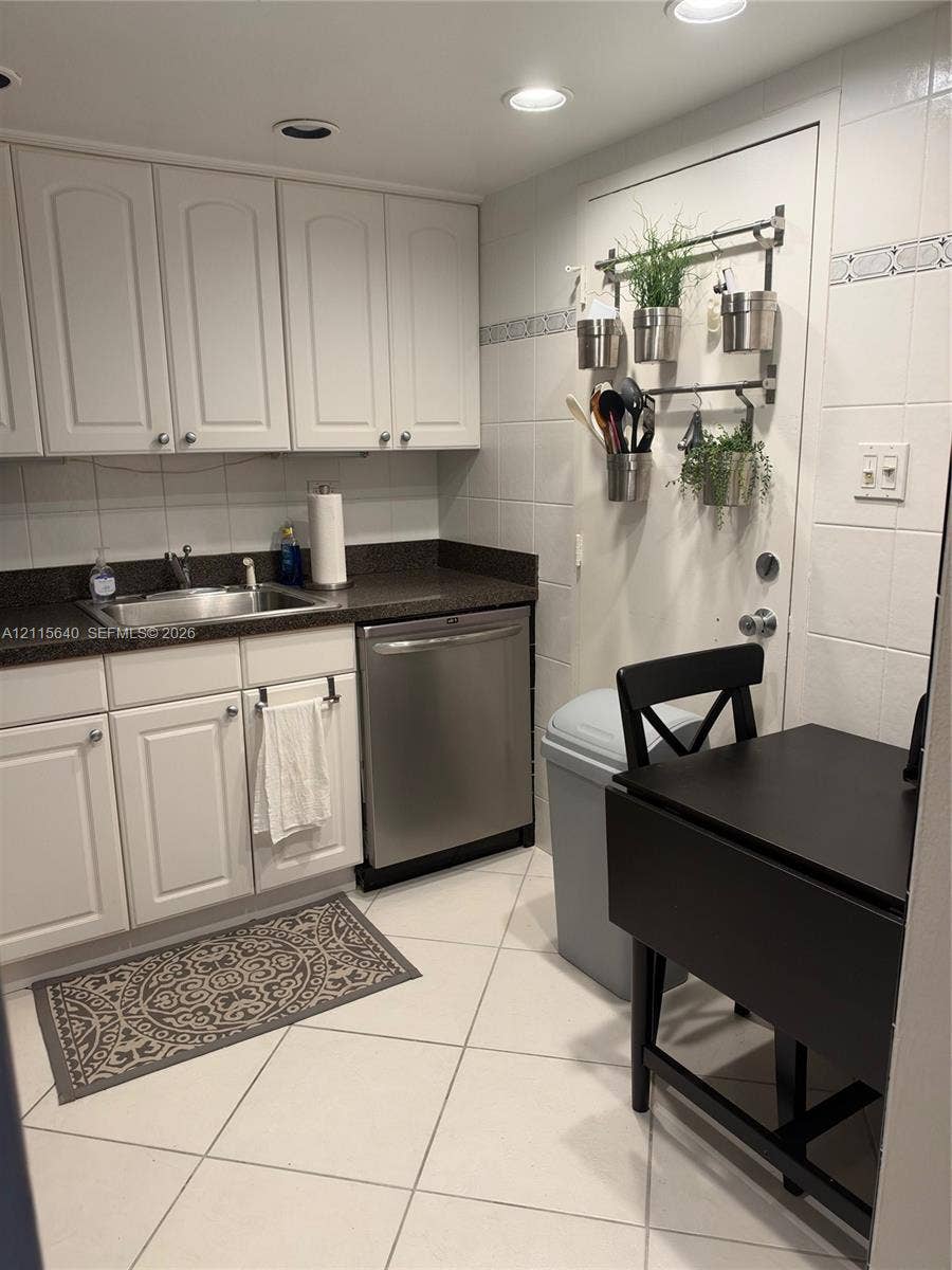 1913 S Ocean Drive, #426, Hallandale Beach, Hallandale Beach, FL 33009 Kitchen featuring white cabinetry, dark stone-finish countertops, an undermount stainless steel sink, a stainless steel dishwasher, and tile flooring