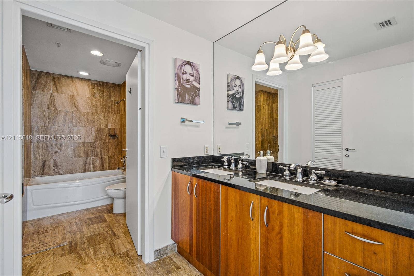 300 S Biscayne Boulevard, #T-3604, Miami, FL 33131 Dual-vanity cabinet with stone countertop, drop-in rectangular sinks, and multi-light vanity fixture