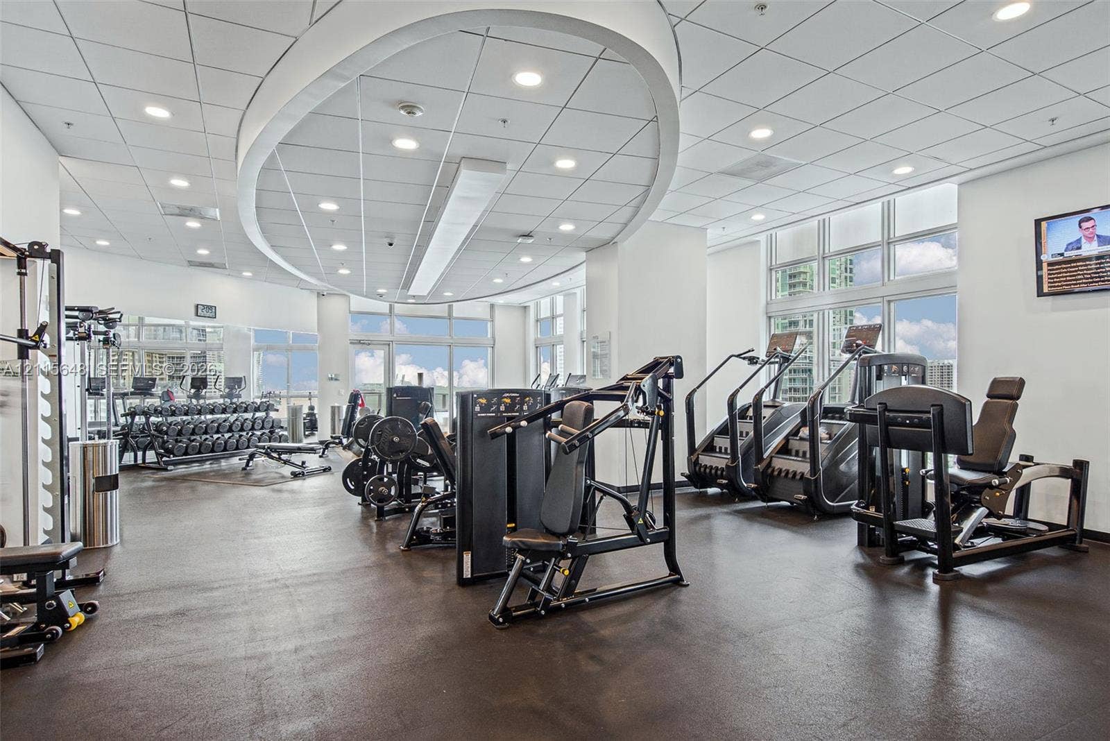 300 S Biscayne Boulevard, #T-3604, Miami, FL 33131 Fitness center featuring high ceilings with custom circular recessed lighting, rubberized flooring, and floor-to-ceiling windows