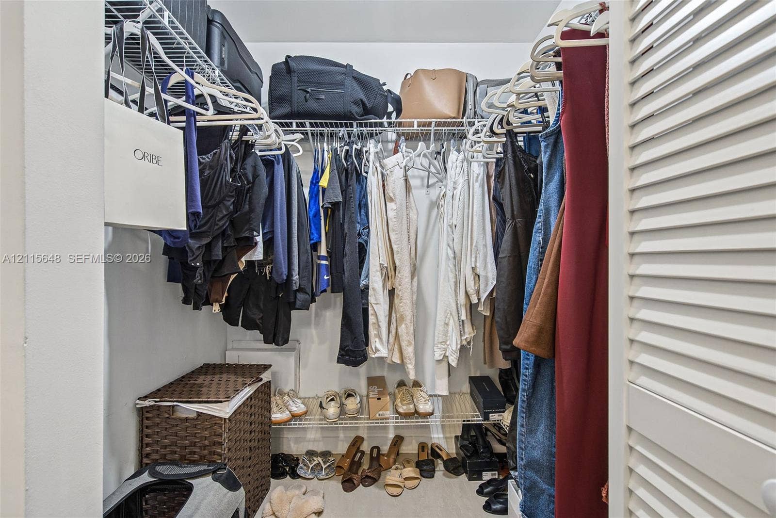 300 S Biscayne Boulevard, #T-3604, Miami, FL 33131 Walk-in closet featuring tiered wire shelving, double-hanging rods, and white louvered doors