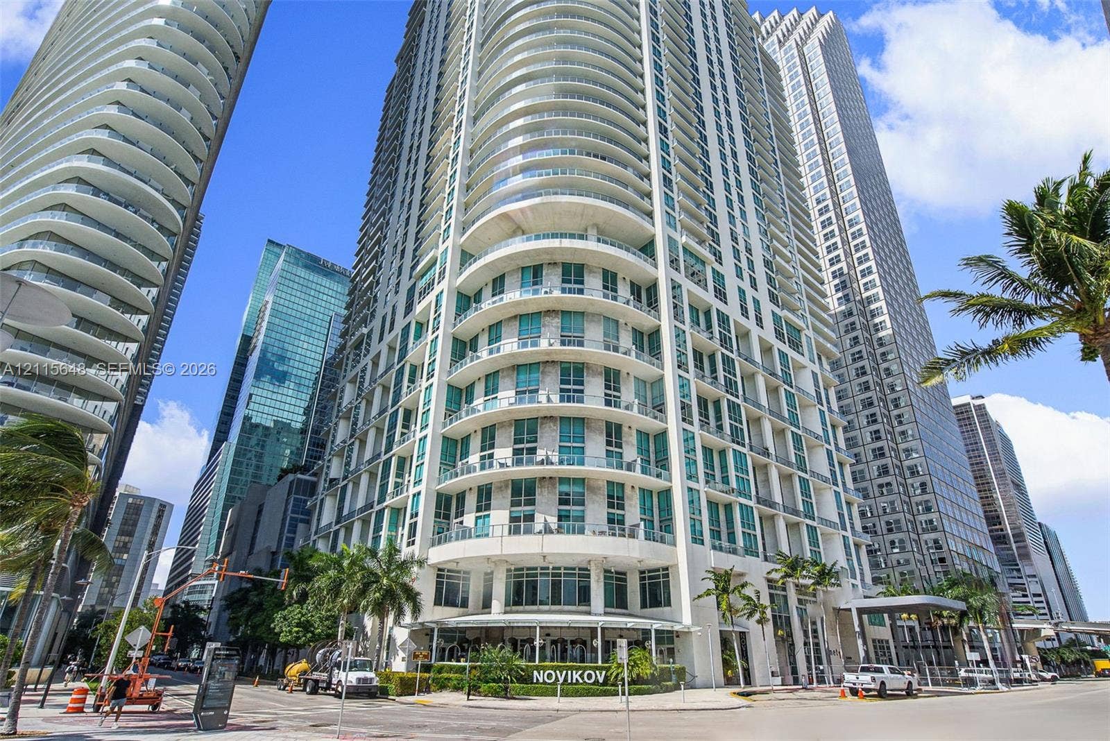 300 S Biscayne Boulevard, #T-3604, Miami, FL 33131 High-rise building exterior featuring curved architectural design, floor-to-ceiling glass windows, and wrap-around balconies