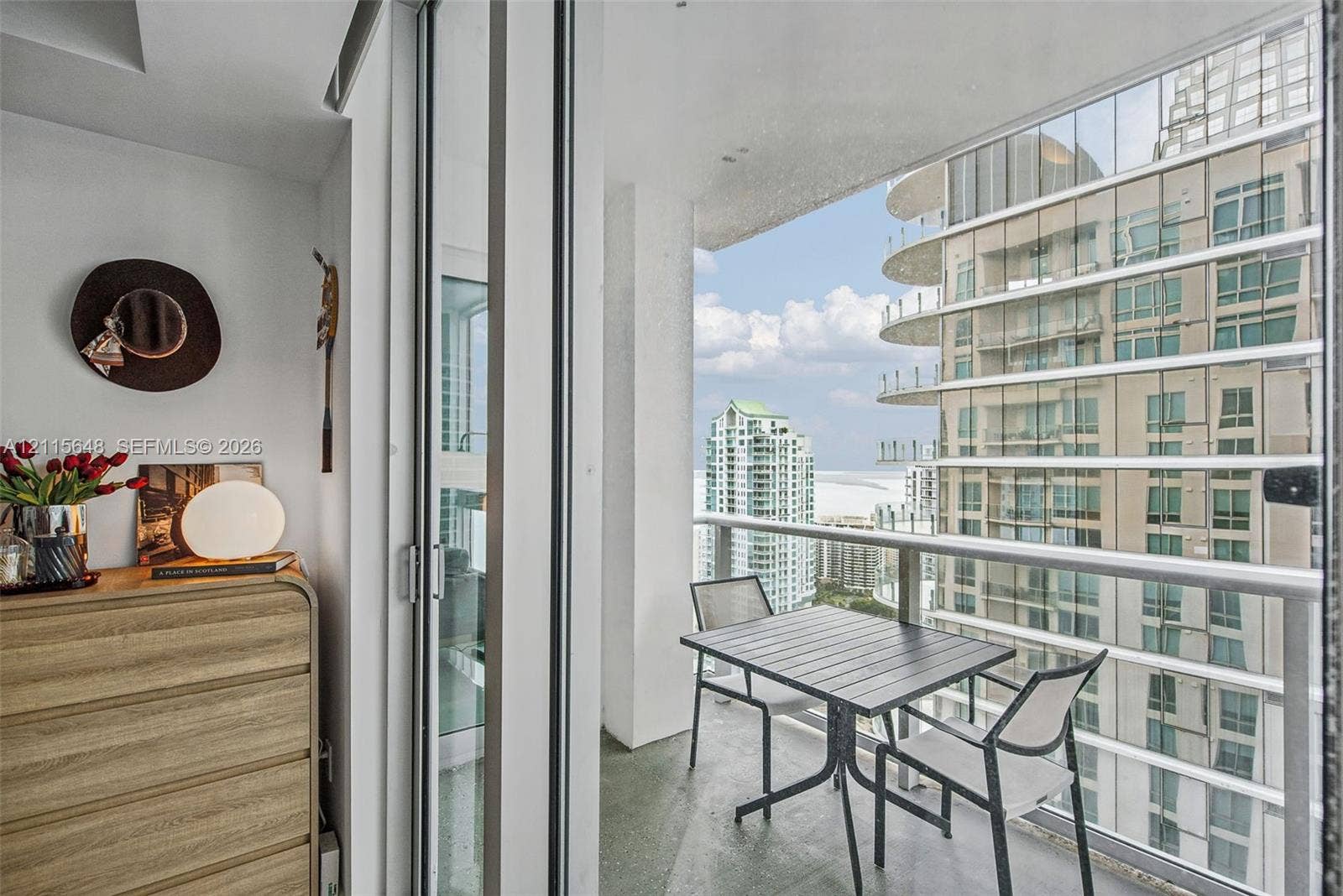 300 S Biscayne Boulevard, #T-3604, Miami, FL 33131 Private balcony featuring floor-to-ceiling glass sliding doors, a metal railing, and concrete flooring