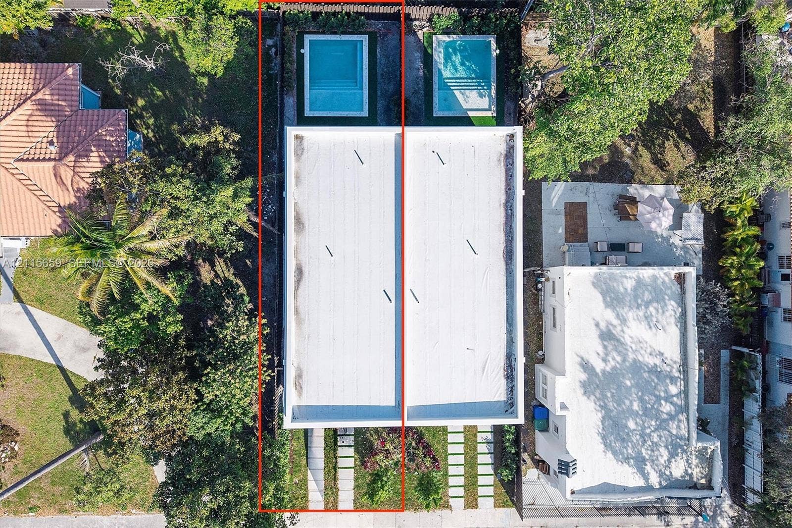 4719 N Miami Avenue, Miami, FL 33127 Aerial perspective of a property featuring a flat roofline, individual in-ground swimming pools, and concrete paver driveway strips