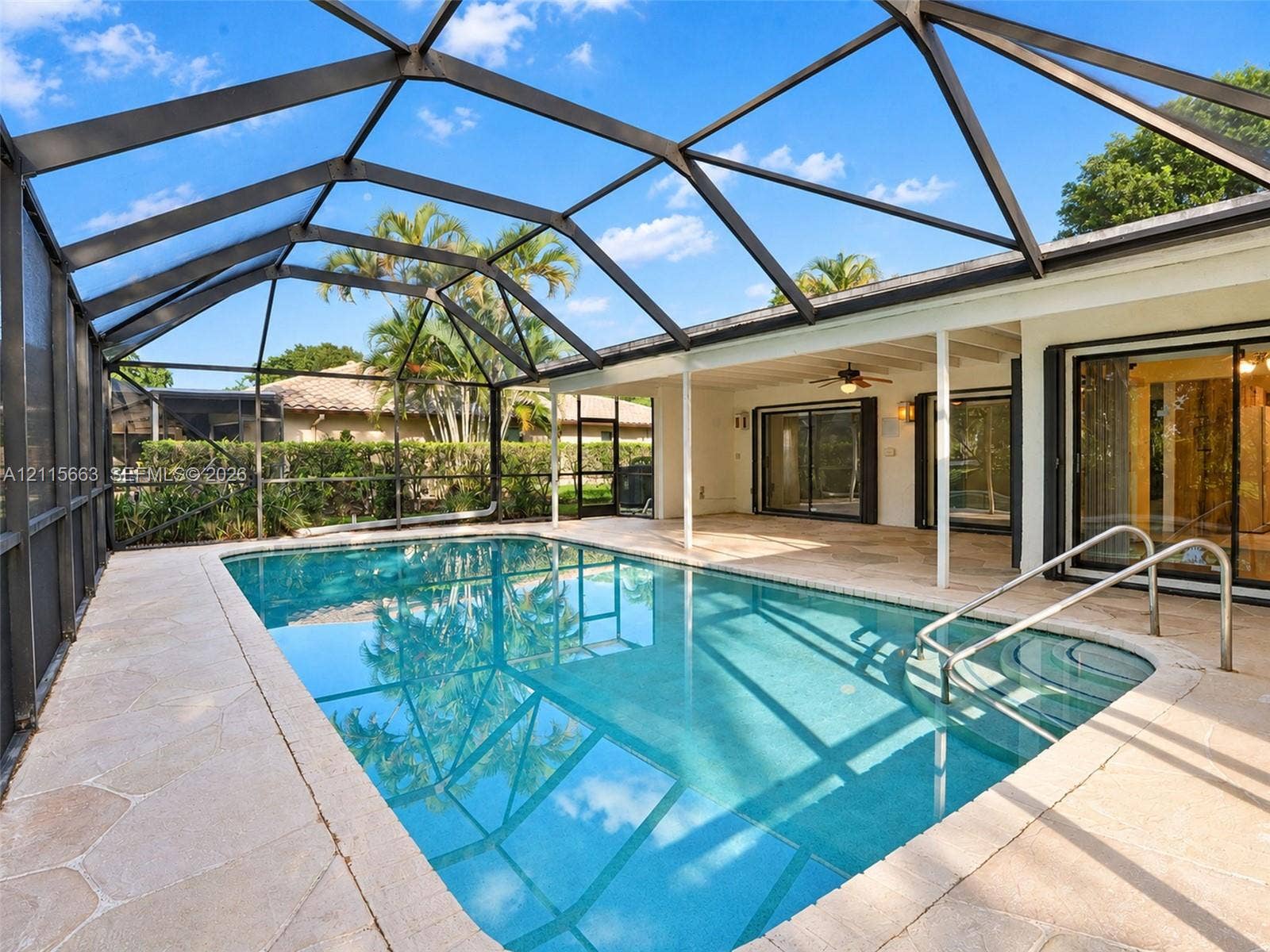 9788 NW 18th Street, Coral Springs, FL 33071 Screen-enclosed swimming pool with stone-finish paver deck and built-in steps
