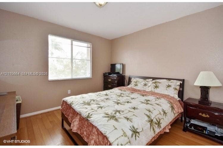 19409 NW 24th Place, Pembroke Pines, FL 33029 Neutral-toned interior space featuring wood-finish flooring and a horizontal sliding window