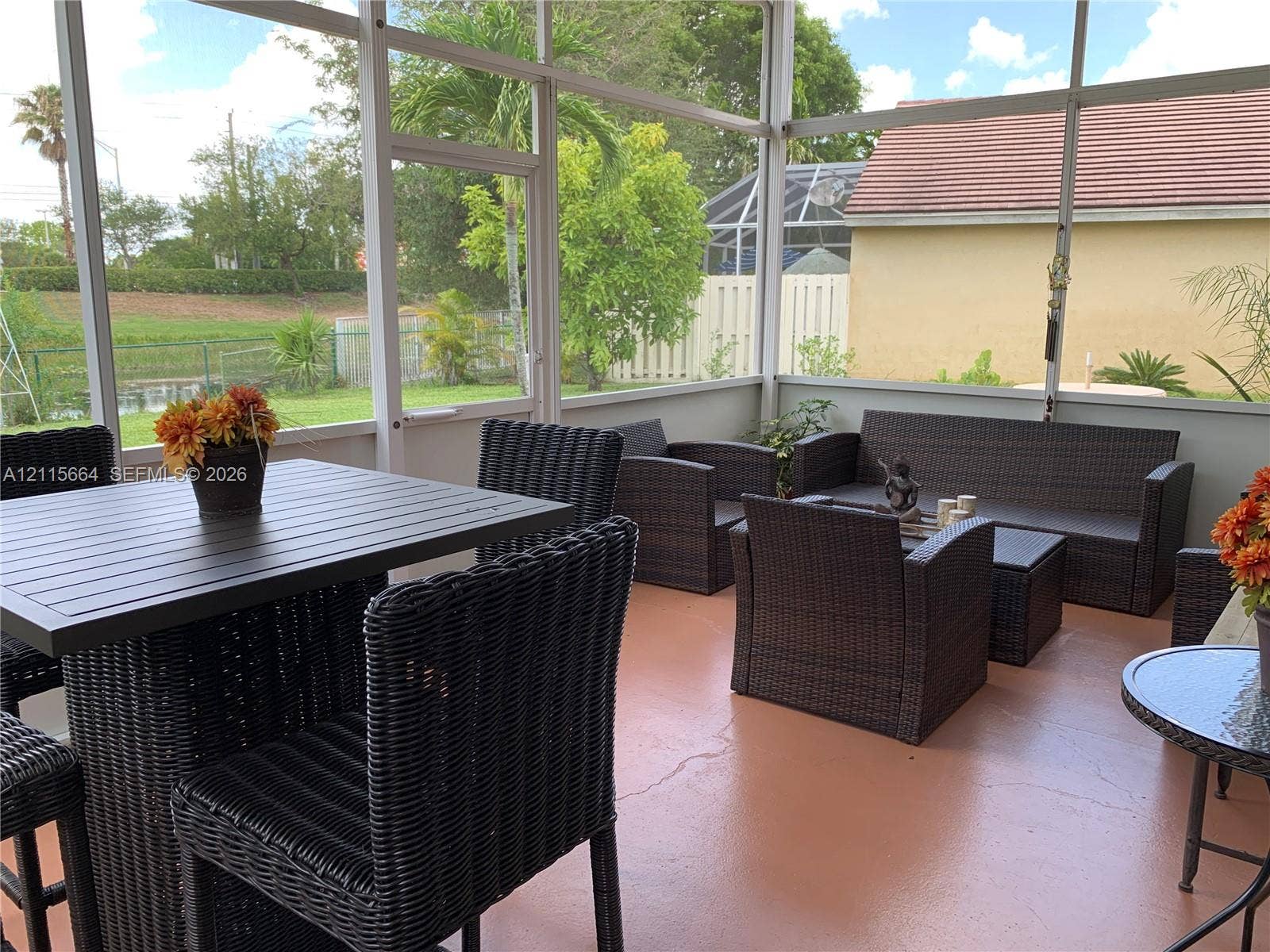 19409 NW 24th Place, Pembroke Pines, FL 33029 Screened-in lanai featuring a solid-surface floor, aluminum framing, and water-facing exposure