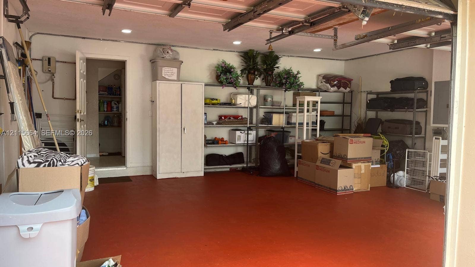 19409 NW 24th Place, Pembroke Pines, FL 33029 Multi-car garage featuring a painted concrete floor, recessed lighting, and a dedicated utility doorway