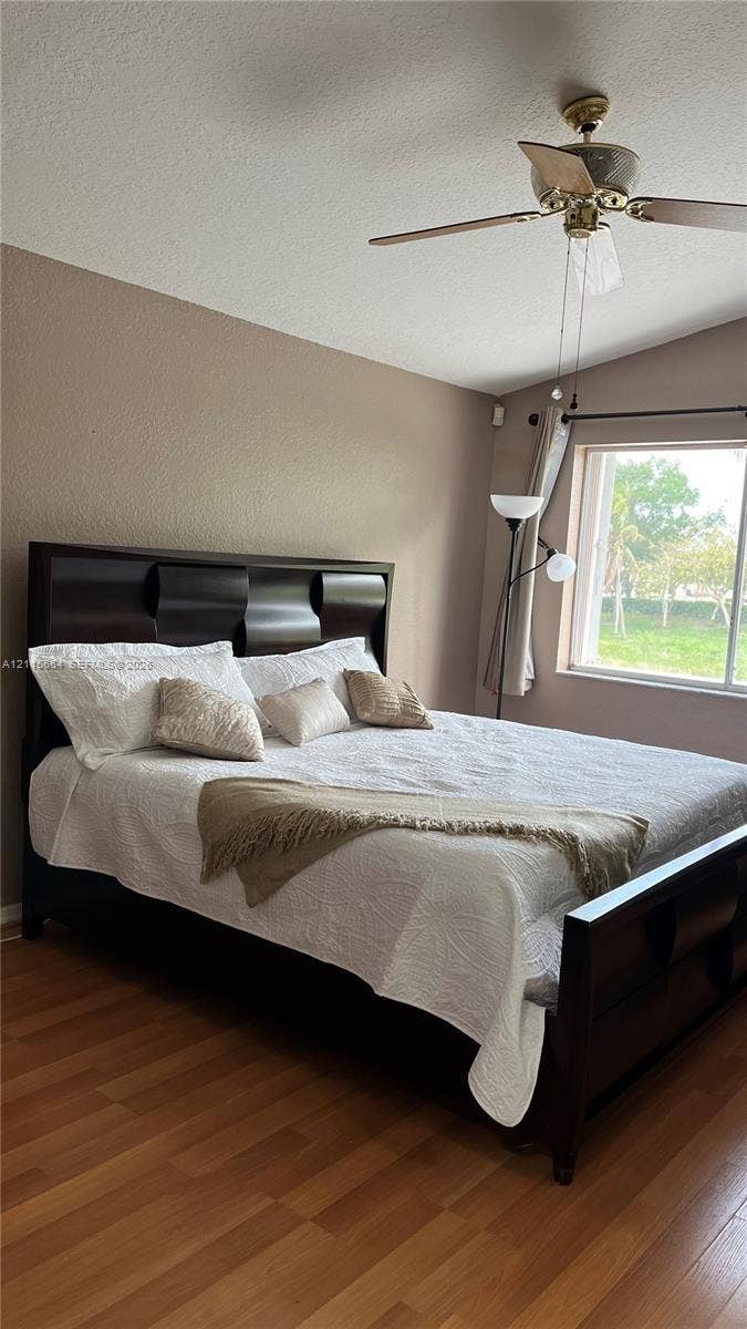19409 NW 24th Place, Pembroke Pines, FL 33029 Vaulted ceilings, wood-finish flooring, and a multi-blade ceiling fan with integrated lighting