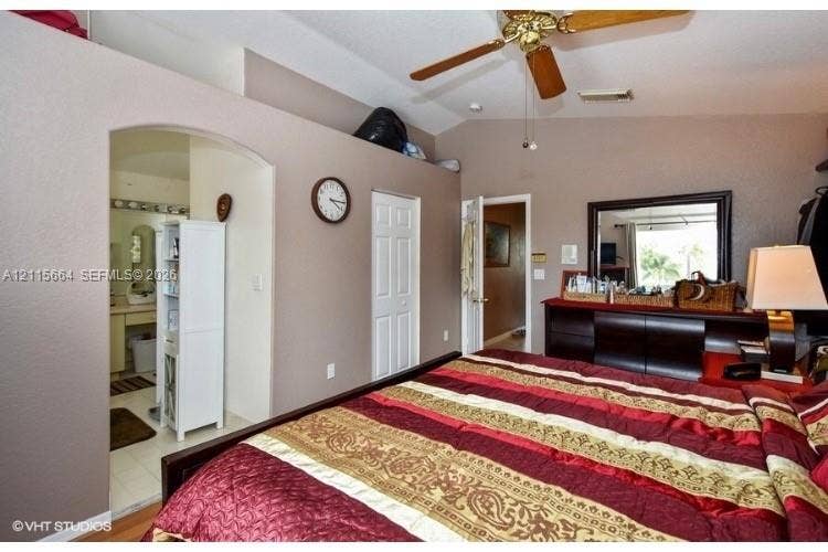 19409 NW 24th Place, Pembroke Pines, FL 33029 Vaulted ceilings featuring a polished brass ceiling fan and interior archway entrance