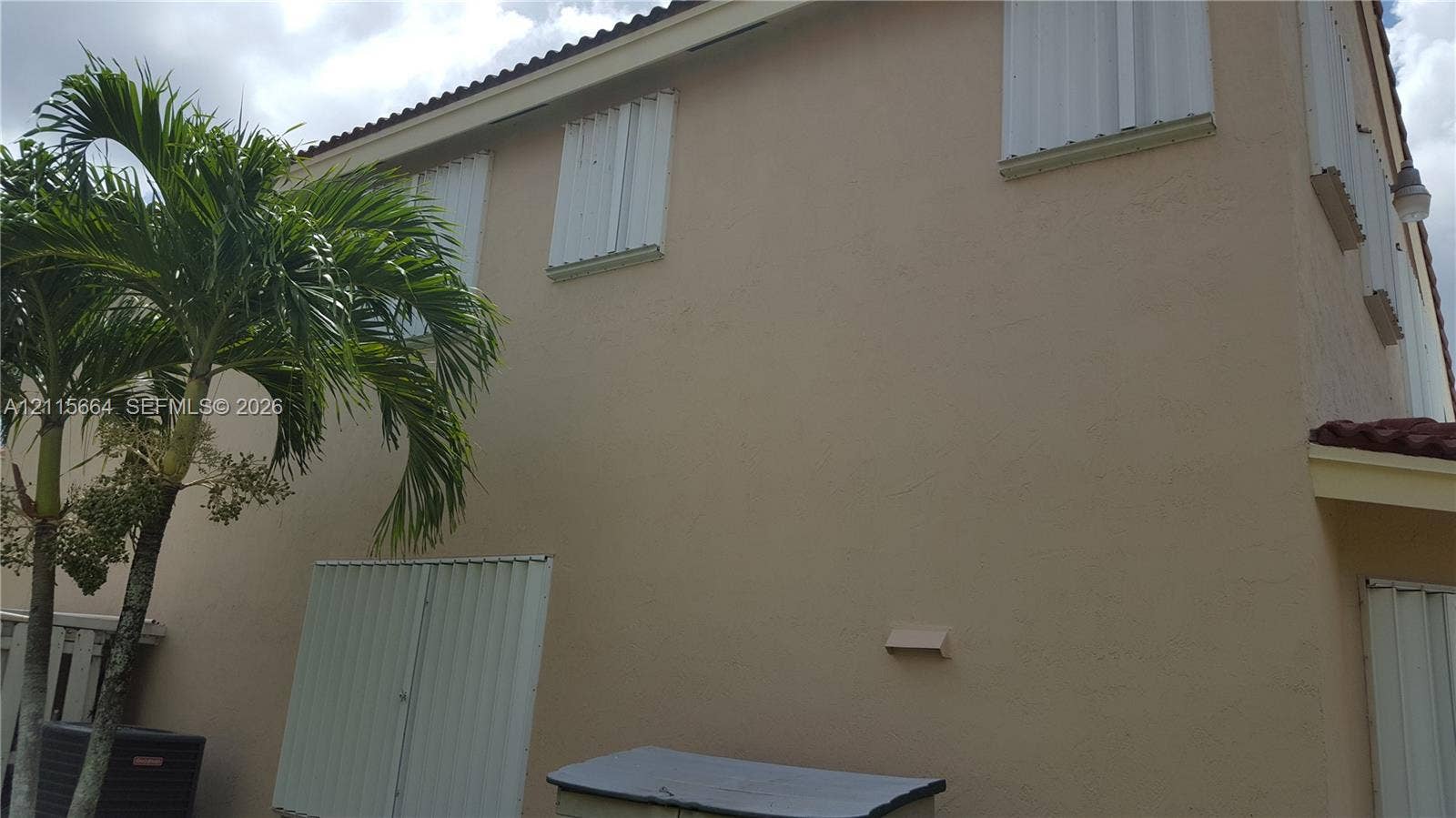 19409 NW 24th Place, Pembroke Pines, FL 33029 Two-story exterior featuring a stucco facade, tile roof, and installed metal hurricane shutters