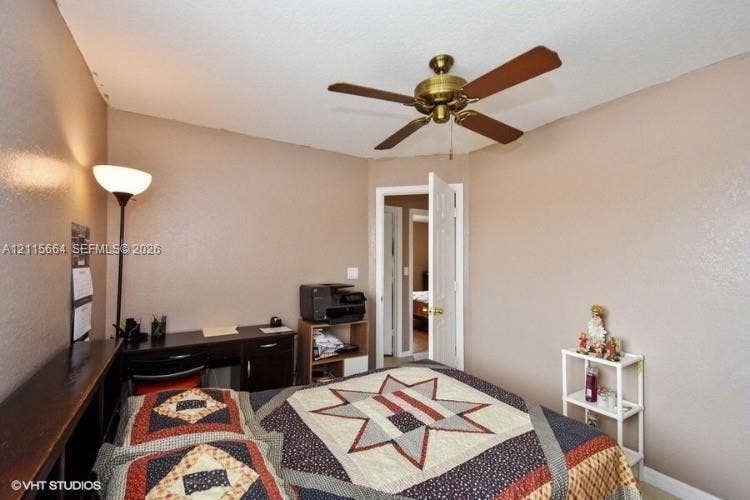 19409 NW 24th Place, Pembroke Pines, FL 33029 Interior room featuring a textured ceiling and a mounted brass-finish ceiling fan with wood-tone blades