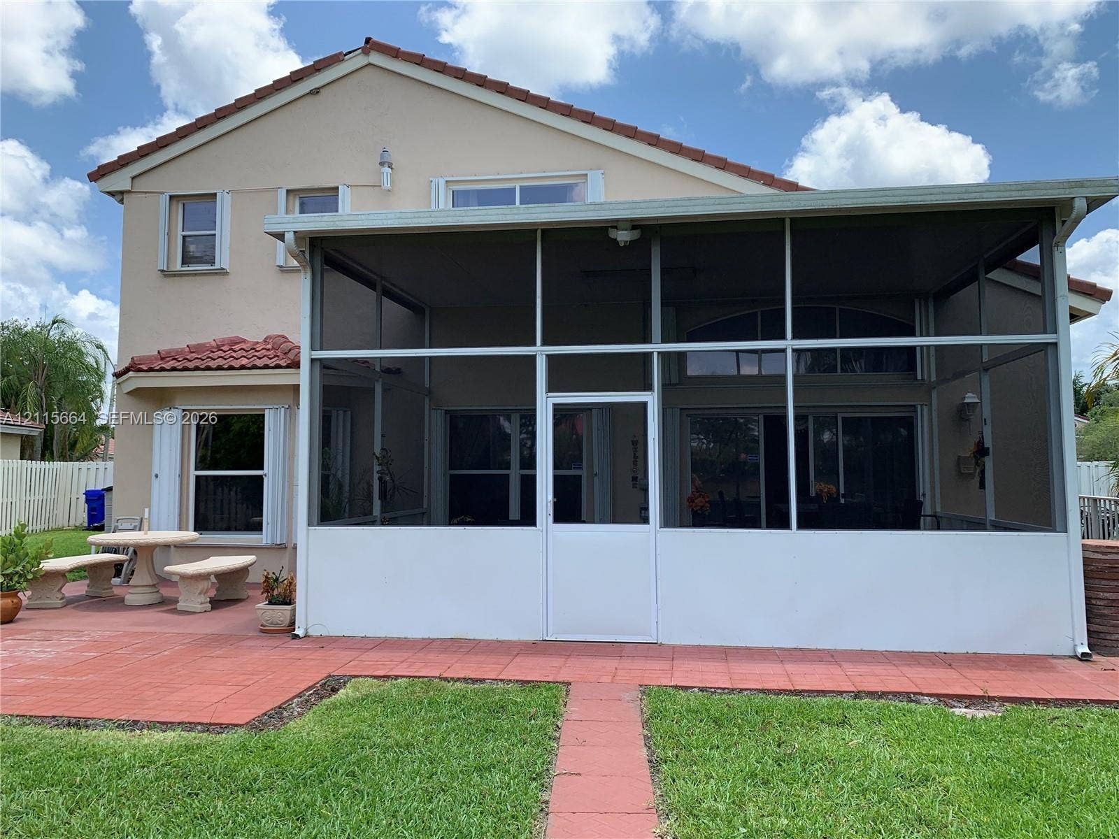 19409 NW 24th Place, Pembroke Pines, FL 33029 Two-story exterior featuring a screened-in lanai, tile patio, and clay-tile roof