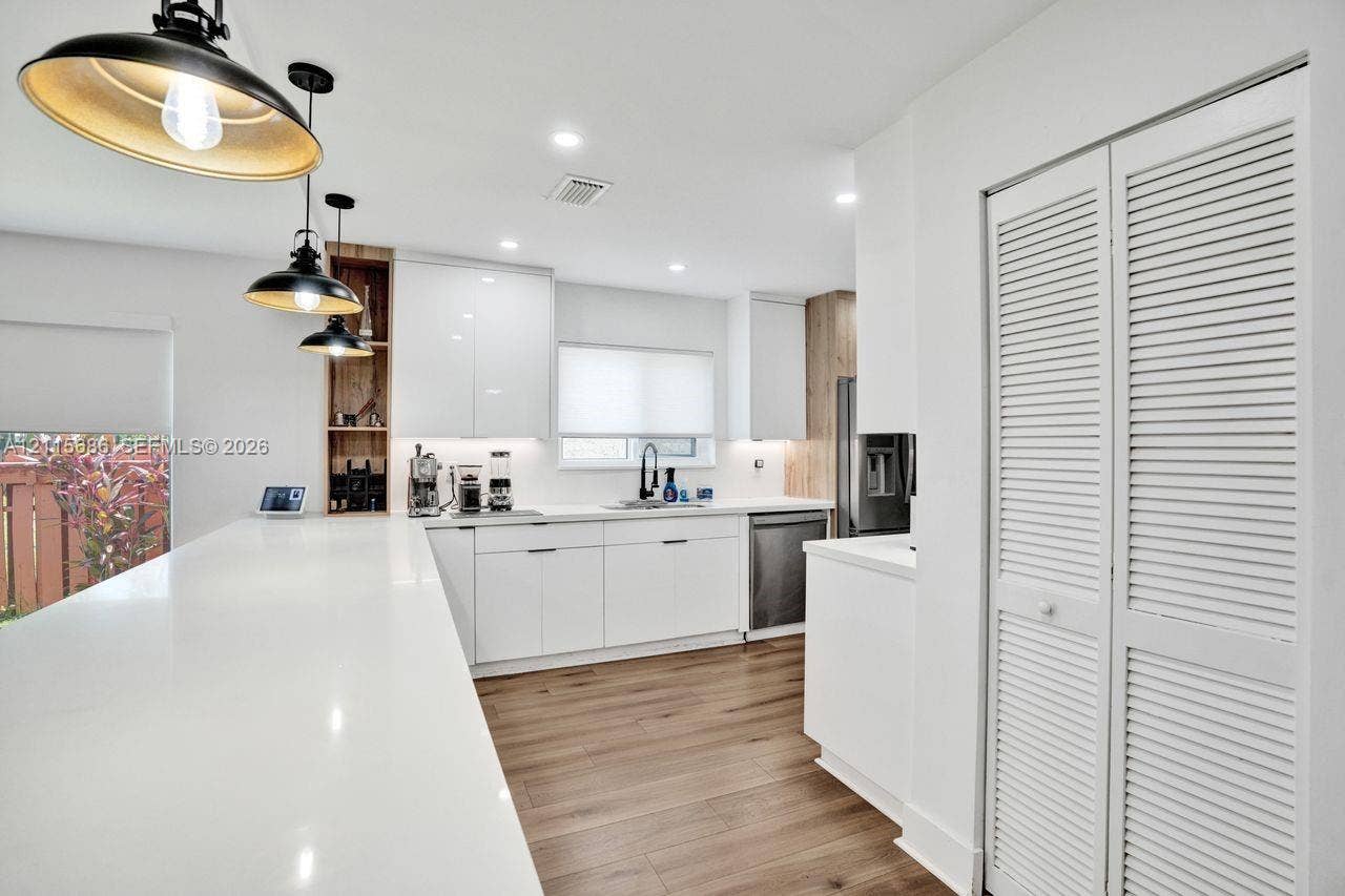 8946 SW 150th Ct Circle E, Miami, Miami, FL 33196 Kitchen featuring white cabinetry, quartz countertops, wood-finish flooring, recessed lighting, and three pendant lights