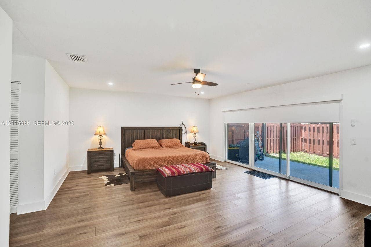 8946 SW 150th Ct Circle E, Miami, Miami, FL 33196 Wood-finish flooring, recessed lighting, ceiling fan with integrated light fixture, and sliding glass doors with roll-down shades