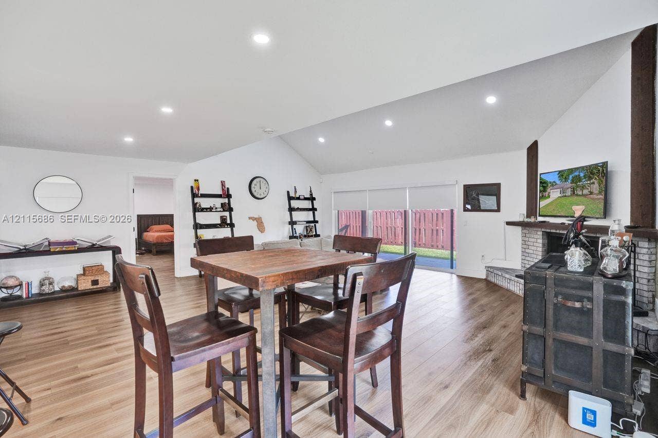 8946 SW 150th Ct Circle E, Miami, Miami, FL 33196 Vaulted ceilings with recessed lighting, wood-finish flooring, and a brick-surround fireplace