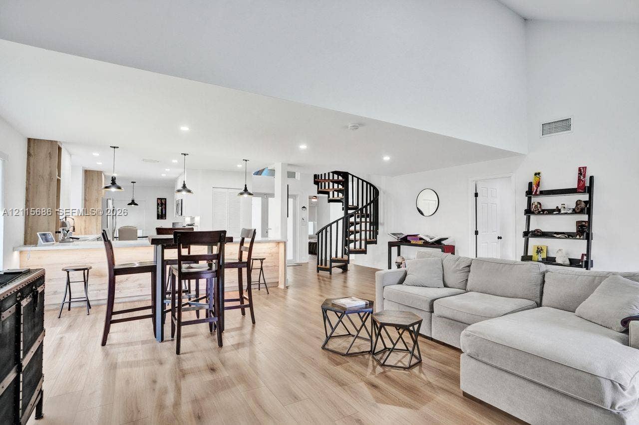 8946 SW 150th Ct Circle E, Miami, Miami, FL 33196 Vaulted ceilings, open-concept floor plan, spiral staircase, wood-finish flooring, and kitchen island with integrated lighting