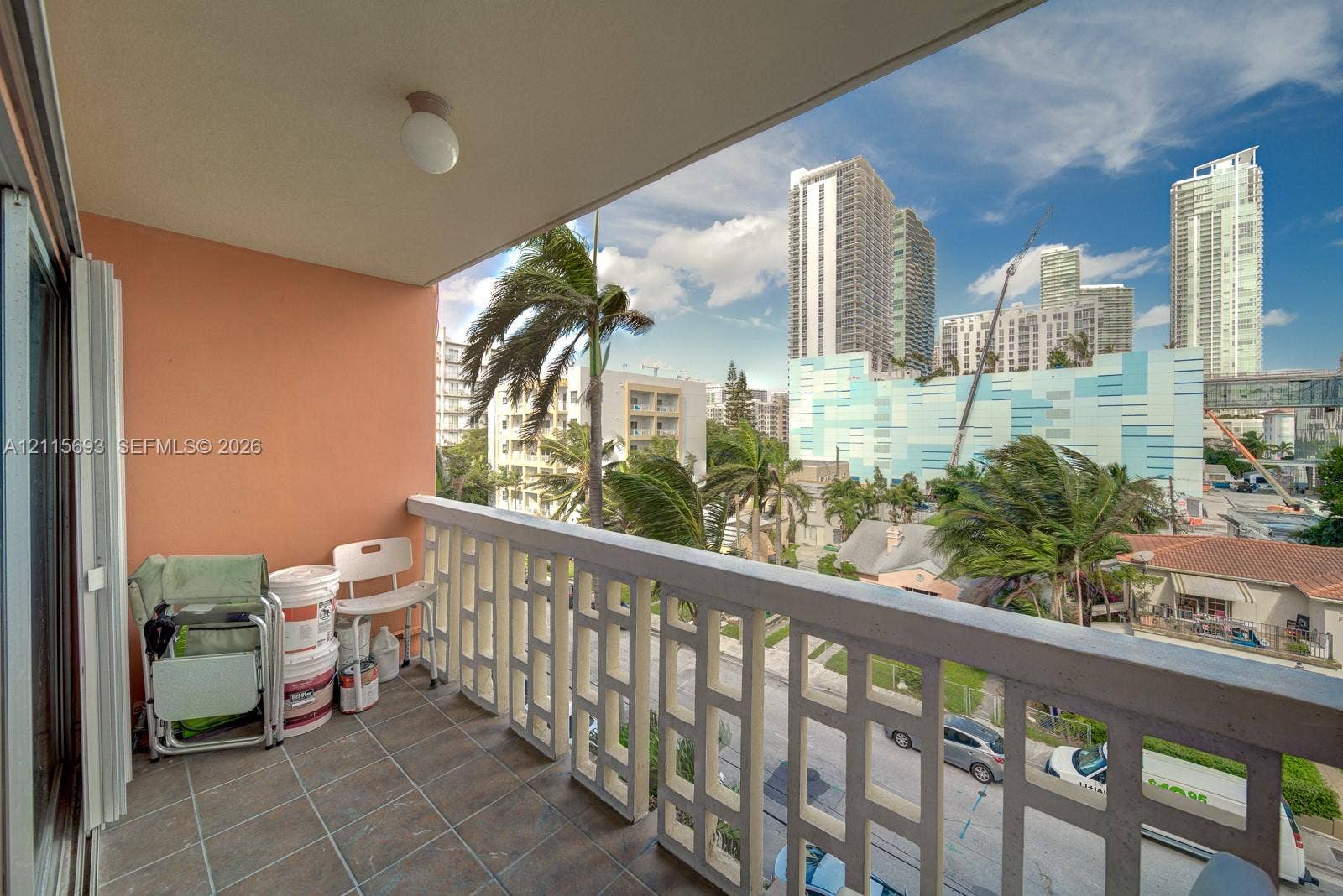 Covered balcony featuring tile flooring and a decorative geometric balustrade