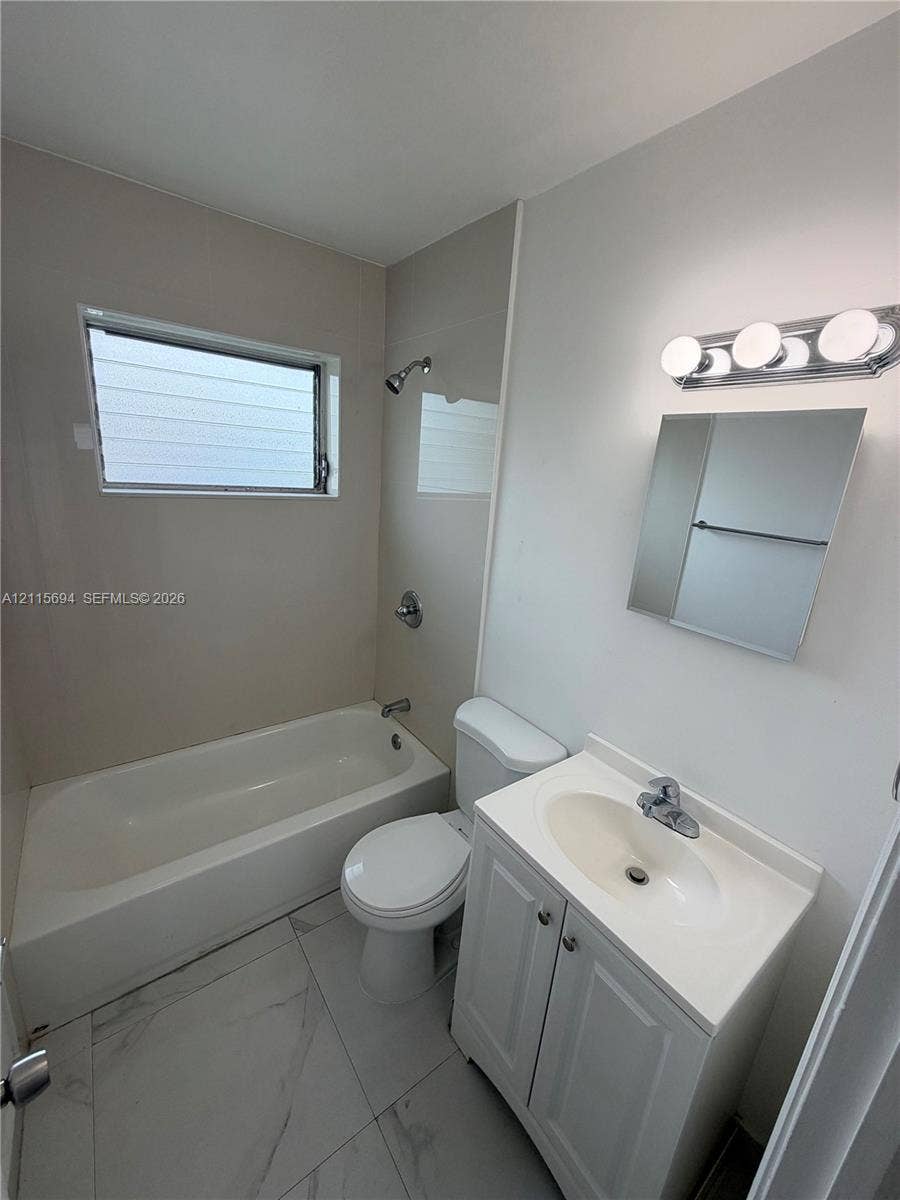 619 SW 7th Avenue, #7, Miami, Miami, FL 33130 Bathroom featuring a shower-tub combination, vanity with an integrated sink, polished chrome fixtures, wall-mounted mirror, and large-format tile flooring