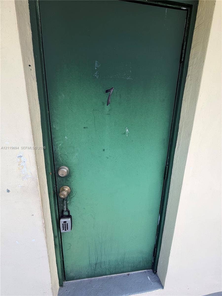 619 SW 7th Avenue, #7, Miami, Miami, FL 33130 Green painted exterior door featuring a metal frame and a cylindrical knob set