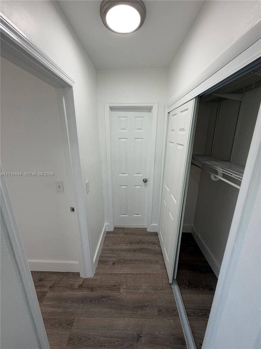 619 SW 7th Avenue, #7, Miami, Miami, FL 33130 Wood-finish flooring, flush-mount ceiling lighting, four-panel interior door, and reach-in closet featuring sliding doors and built-in wire shelving