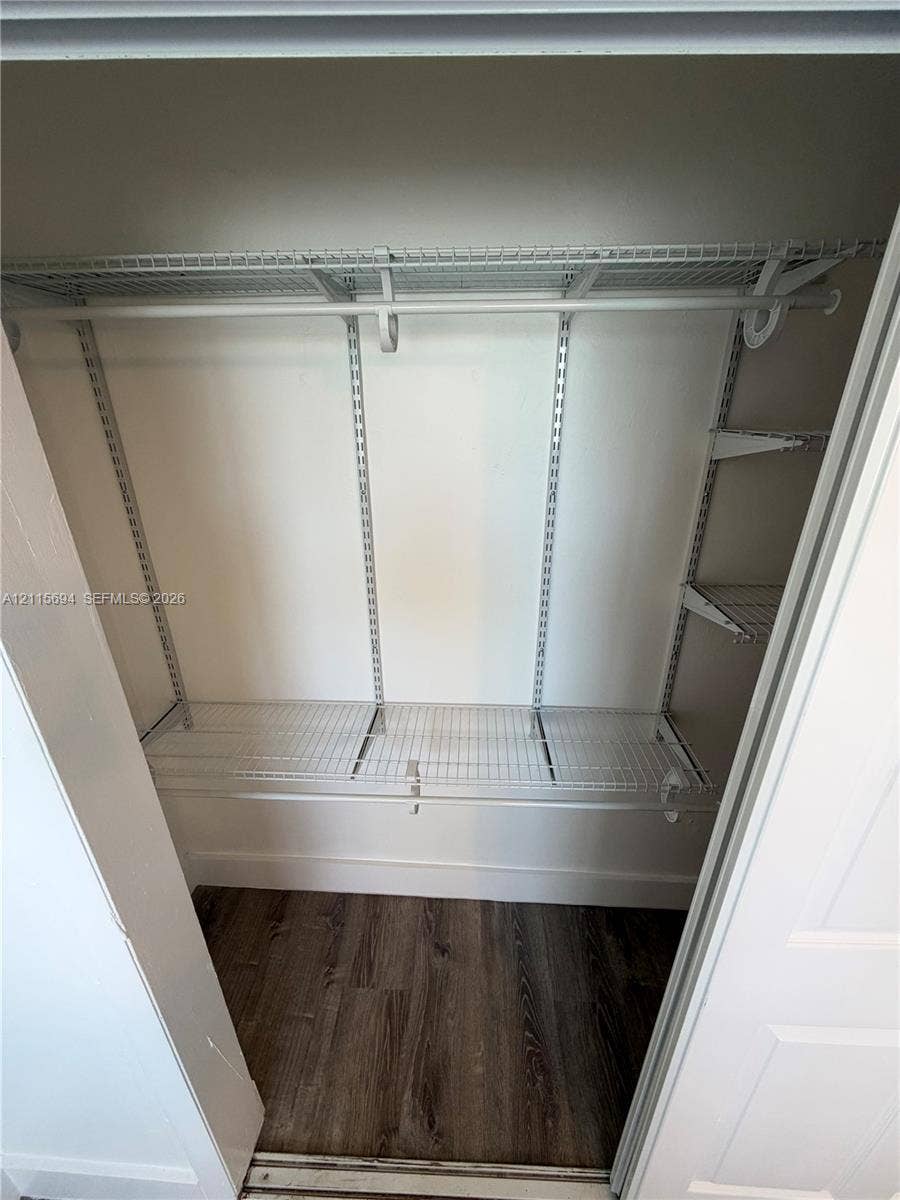 619 SW 7th Avenue, #7, Miami, Miami, FL 33130 Storage space featuring white wire shelving, adjustable metal support tracks, and wood-finish flooring